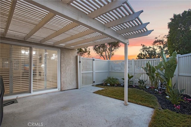 patio terrace at dusk featuring a pergola