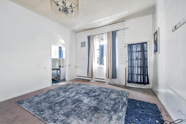 unfurnished room with carpet floors, a baseboard radiator, and a textured ceiling