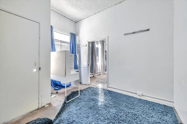 interior space featuring a baseboard radiator and a textured ceiling