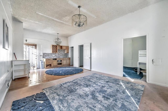 bedroom with carpet flooring, a textured ceiling, and an inviting chandelier