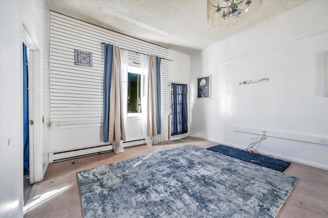 carpeted bedroom featuring a baseboard heating unit and a textured ceiling