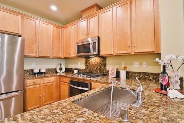 kitchen featuring sink, light brown cabinets, stainless steel appliances, and stone countertops