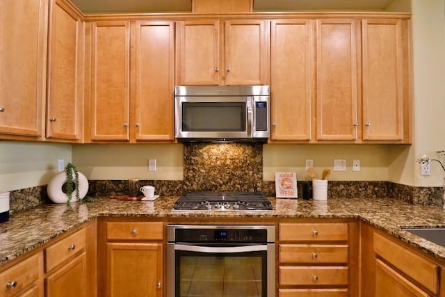 kitchen featuring stone countertops, tasteful backsplash, and appliances with stainless steel finishes