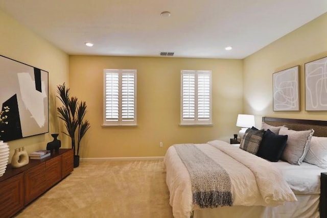 bedroom featuring multiple windows and light colored carpet