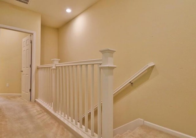 stairs featuring carpet flooring