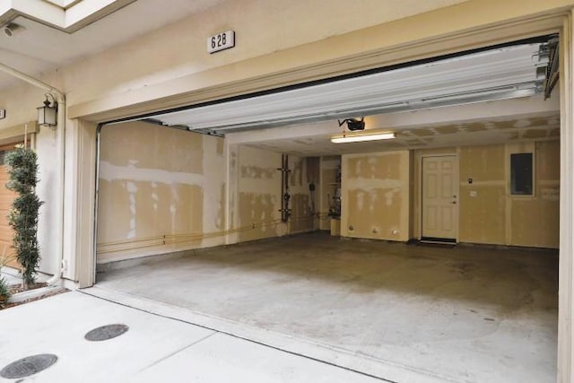 garage with a garage door opener and electric panel