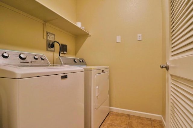 washroom with washing machine and dryer and light tile patterned floors