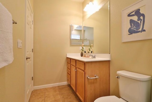 bathroom featuring tile patterned flooring, vanity, and toilet