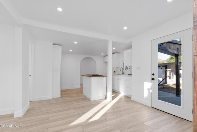 interior space featuring sink and light hardwood / wood-style flooring