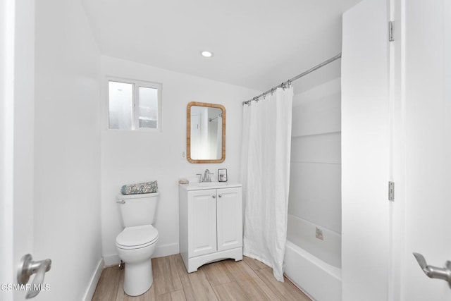 full bathroom featuring vanity, toilet, wood-type flooring, and shower / bath combo with shower curtain