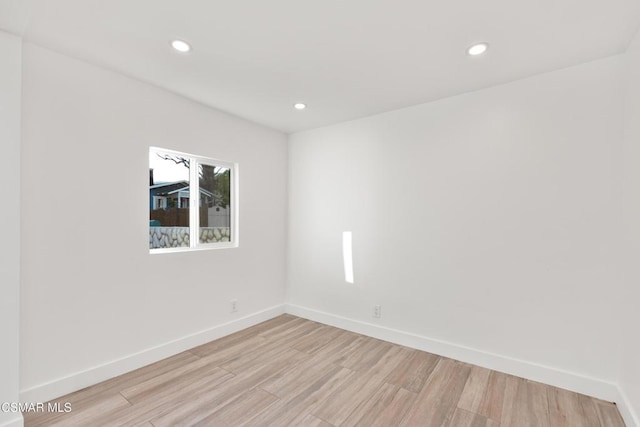 spare room featuring light hardwood / wood-style flooring