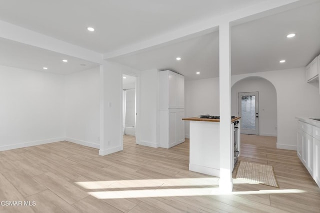 kitchen with white cabinetry, wooden counters, and light wood-type flooring