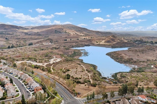drone / aerial view featuring a water and mountain view
