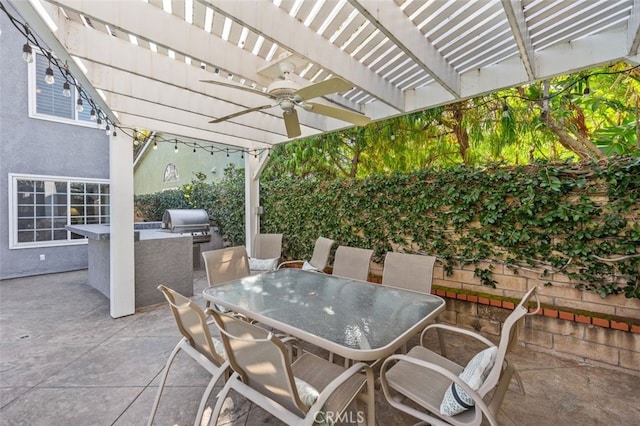 view of patio / terrace with a grill, a pergola, and an outdoor kitchen