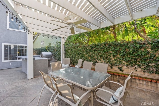 view of patio with ceiling fan, a pergola, an outdoor kitchen, area for grilling, and outdoor dining space