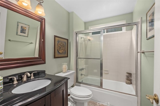 full bathroom featuring vanity, enclosed tub / shower combo, and toilet