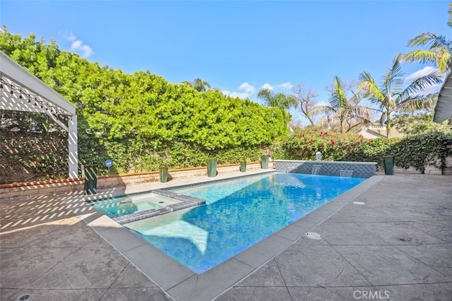 view of swimming pool featuring an in ground hot tub and a patio area