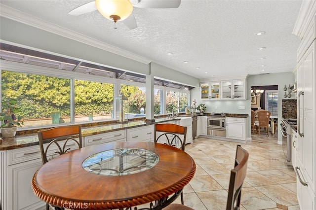 dining area with recessed lighting, a textured ceiling, ceiling fan with notable chandelier, and light tile patterned flooring