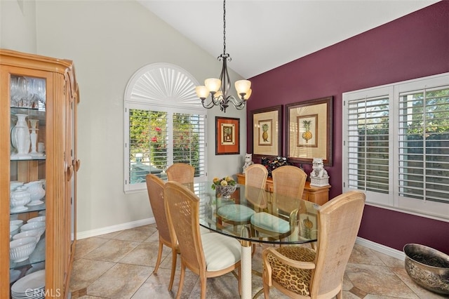 tiled dining room with lofted ceiling and an inviting chandelier