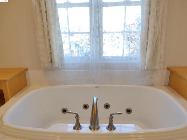 bathroom with a relaxing tiled tub