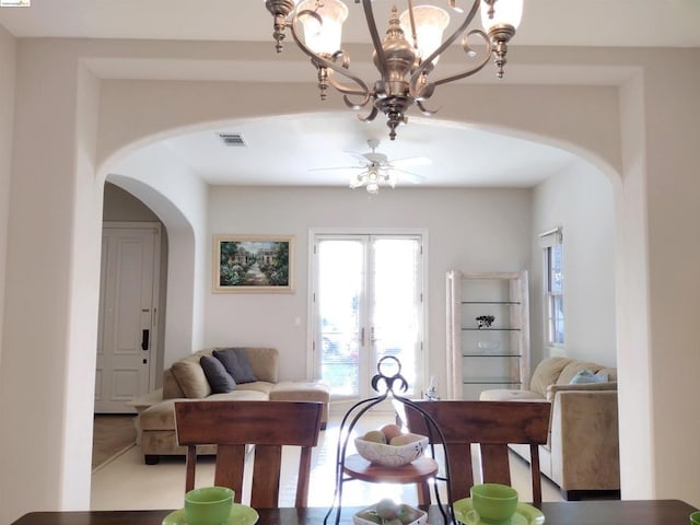 dining space featuring ceiling fan and french doors