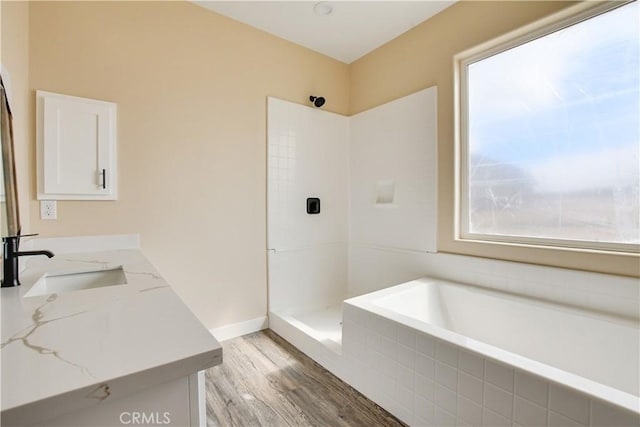 bathroom featuring vanity, hardwood / wood-style floors, and shower with separate bathtub