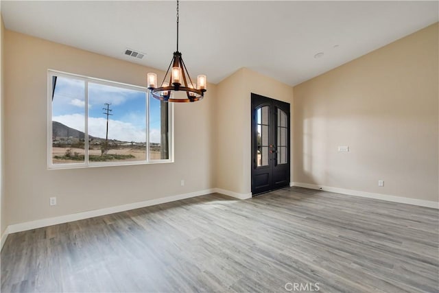 interior space with hardwood / wood-style floors and a notable chandelier