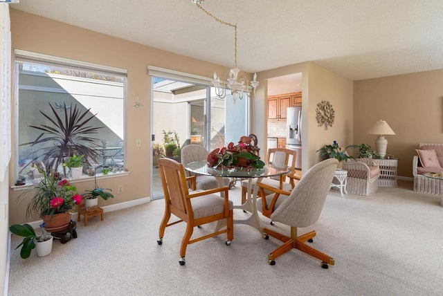 dining space featuring light carpet and a notable chandelier