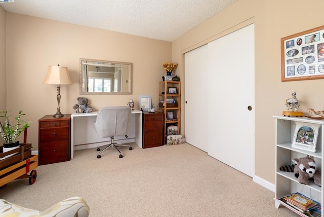 carpeted office with a textured ceiling