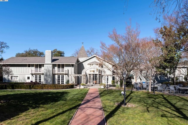 view of property's community with a lawn