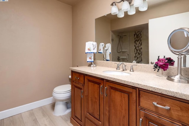 bathroom featuring vanity, toilet, hardwood / wood-style floors, and a shower