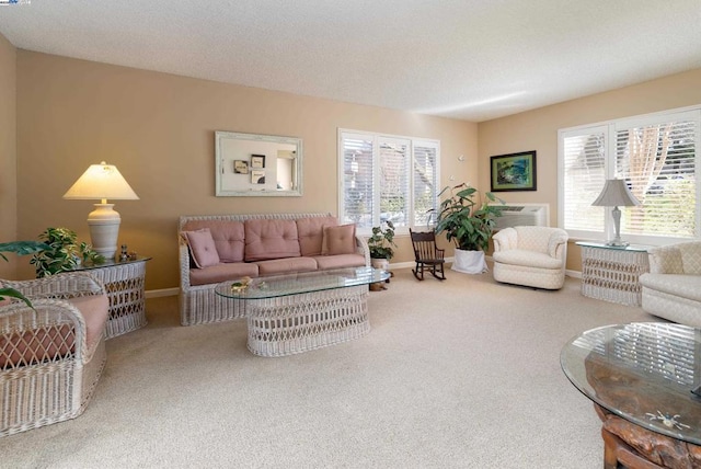 living room featuring a wealth of natural light, carpet floors, and a textured ceiling