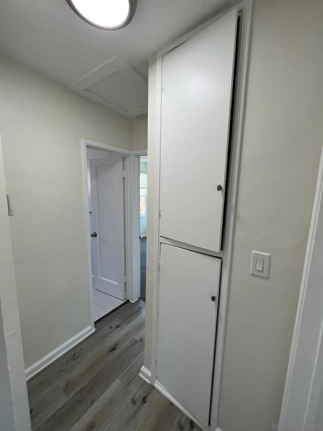 corridor with hardwood / wood-style flooring