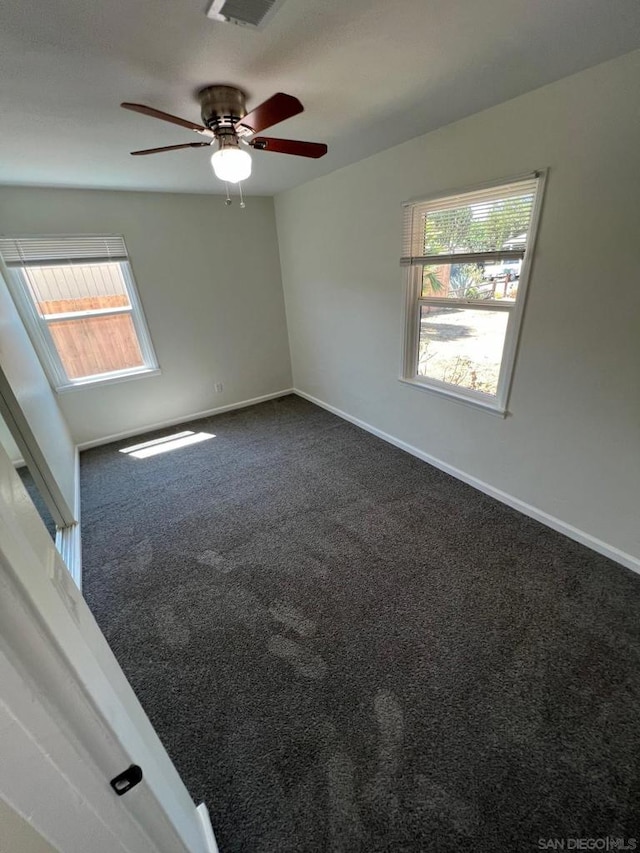 carpeted empty room with ceiling fan