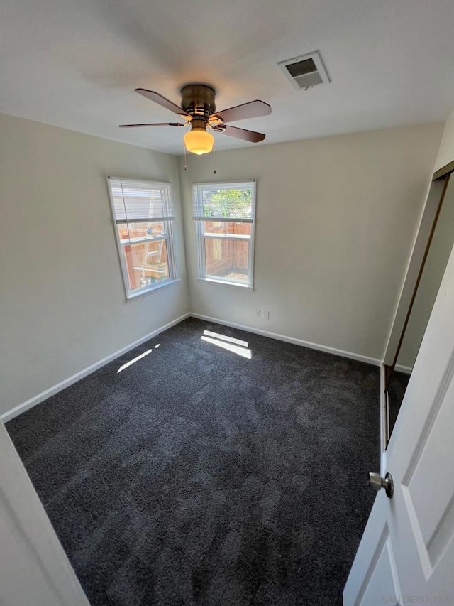 carpeted empty room with ceiling fan