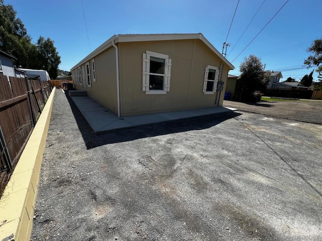 view of property exterior with a patio