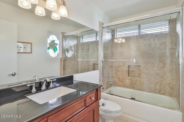 full bathroom with vanity, toilet, and combined bath / shower with glass door