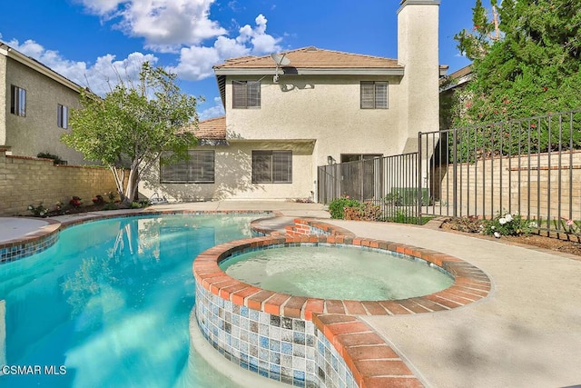 view of pool featuring an in ground hot tub