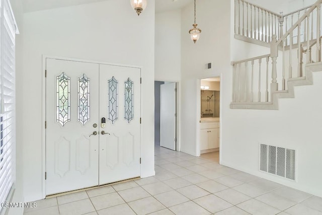 tiled foyer with a high ceiling