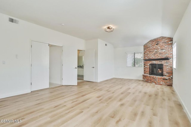 unfurnished living room with a fireplace and light hardwood / wood-style flooring