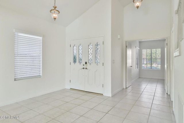 tiled entryway with high vaulted ceiling