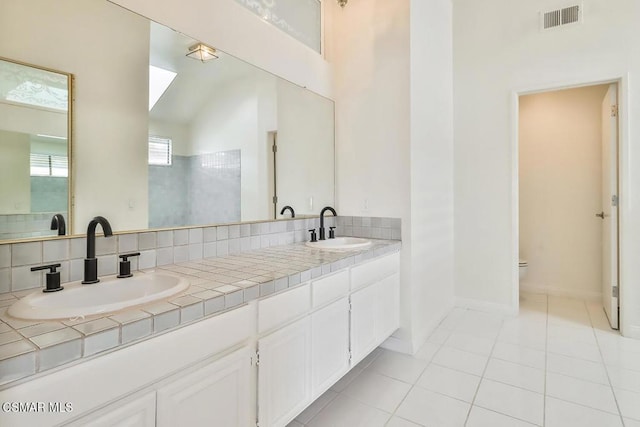 bathroom featuring vanity, toilet, and tile patterned flooring