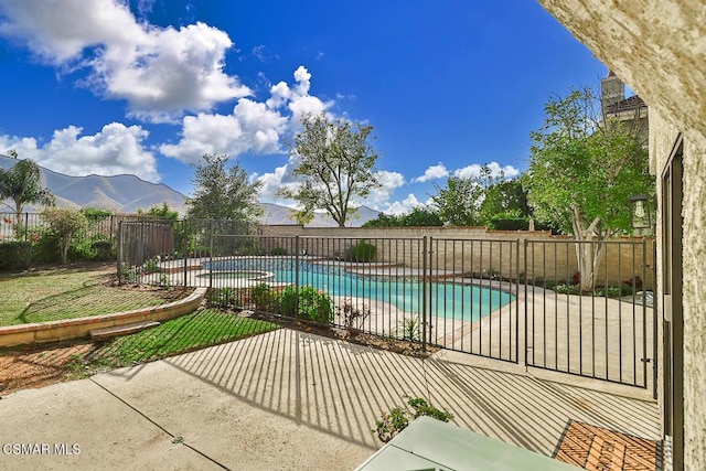 view of swimming pool featuring a mountain view and a patio area