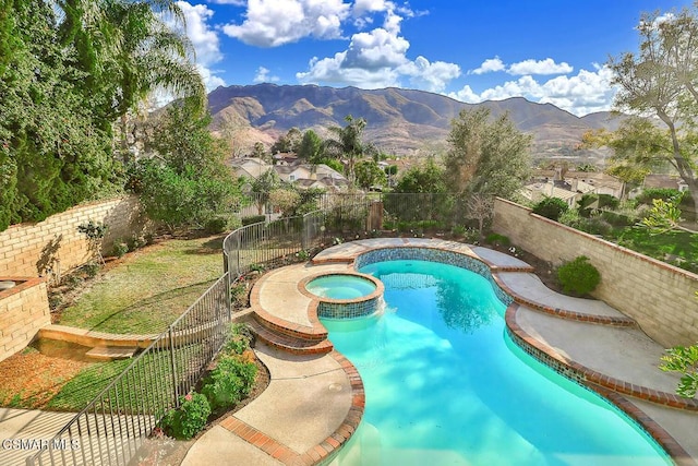 view of swimming pool featuring an in ground hot tub and a mountain view