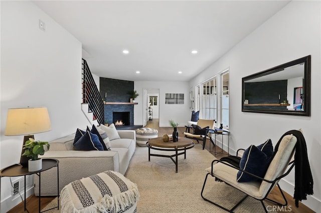 living room with a fireplace and light hardwood / wood-style flooring