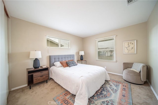 carpeted bedroom with multiple windows