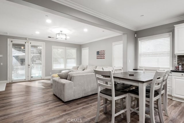 dining space with crown molding and wood-type flooring