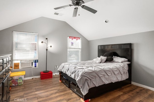 bedroom with vaulted ceiling, dark hardwood / wood-style floors, cooling unit, and ceiling fan