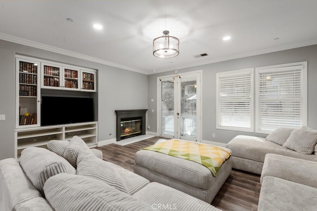 living room with ornamental molding and dark hardwood / wood-style floors