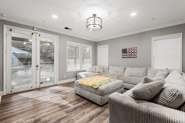 living room featuring wood-type flooring and ornamental molding